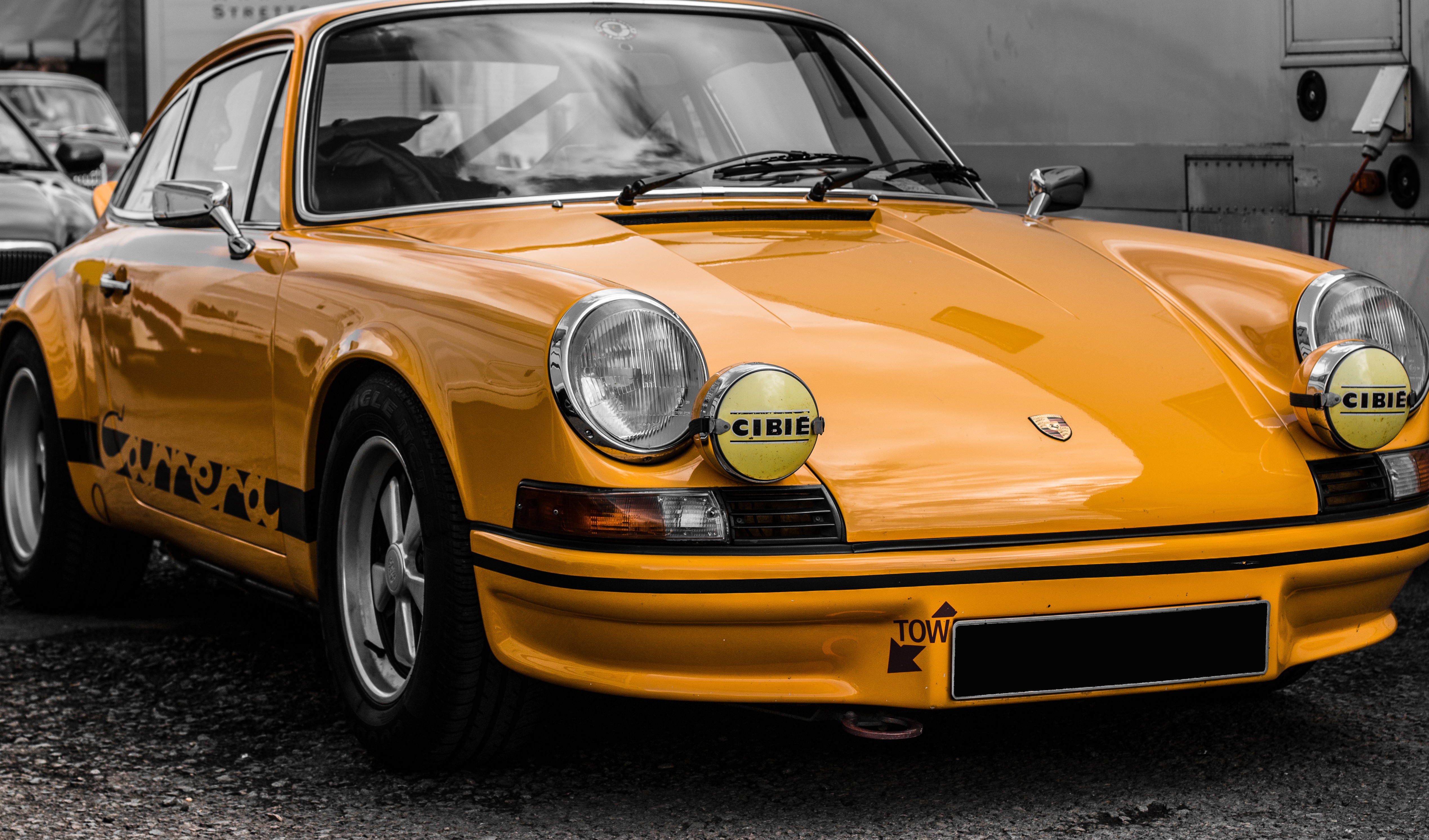 Yellow Porsche 911 Carrera RS with auxiliary rally lights